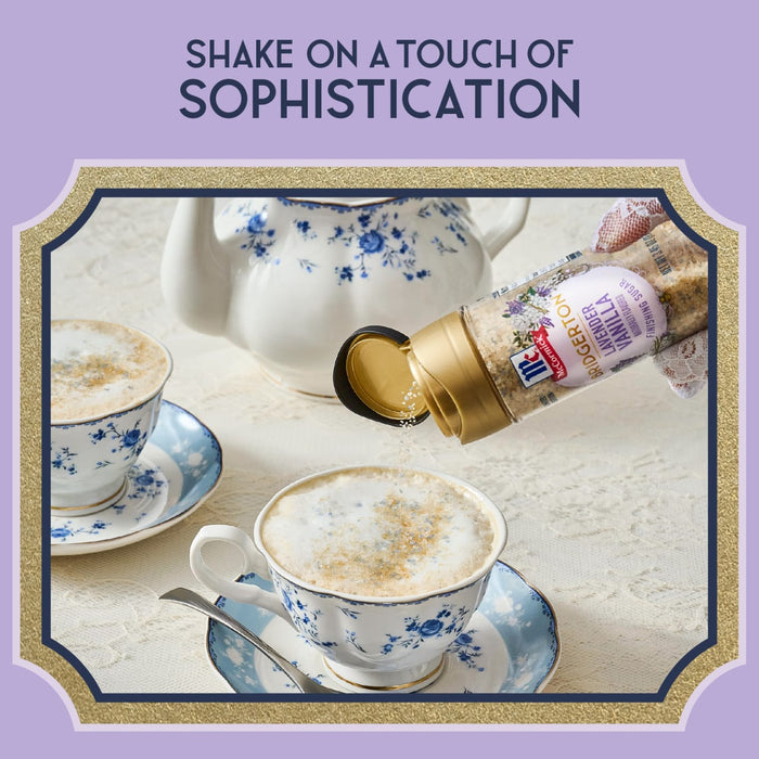 A person is shaking a bottle of a flavored topping over a cup of coffee, suggesting a touch of sophistication.