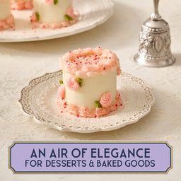 A small, elegantly decorated cake sits on a decorative plate, suggesting a touch of sophistication for desserts and baked goods.