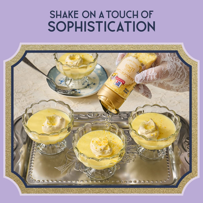 A hand sprinkles a gold-labeled product over custard desserts, suggesting a touch of sophistication.