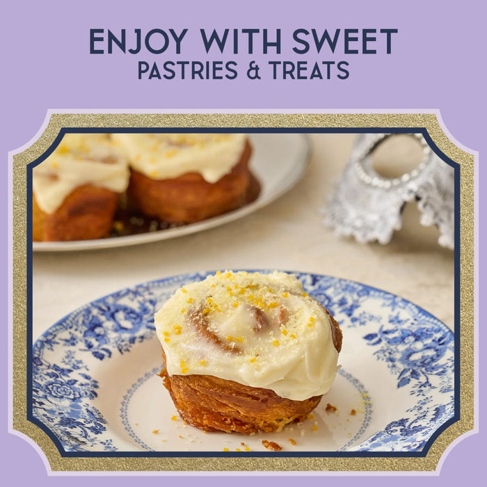 A close-up of sweet pastries with white icing and orange zest, suggesting a delightful treat.