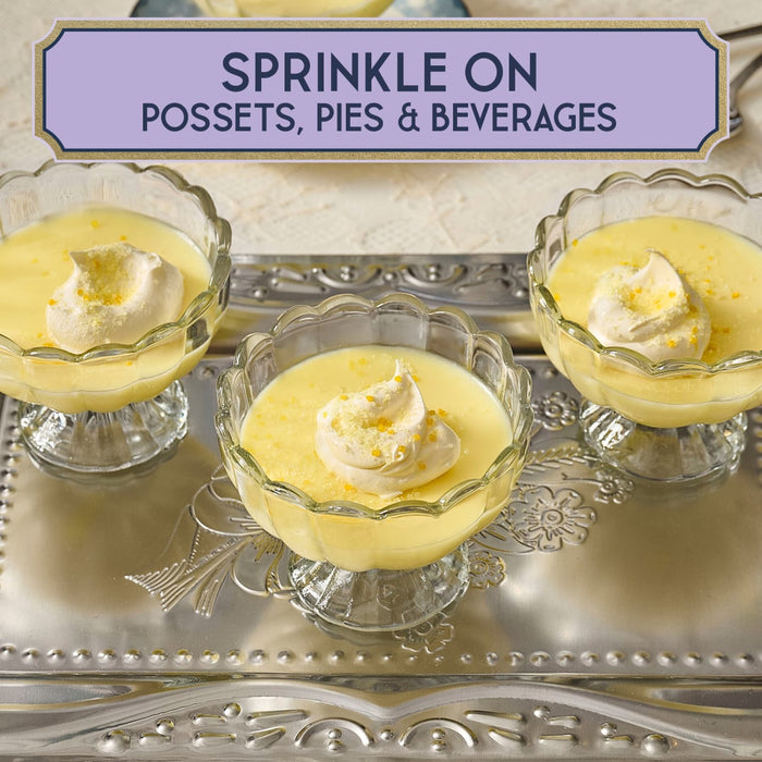 Three glass bowls filled with possets topped with whipped cream and orange zest, suggesting they can be sprinkled on possets, pies, and beverages.