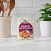 A packet of McCormick Hibachi Chicken Rice mix is displayed on a kitchen counter.