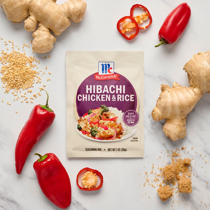 A package of McCormick Hibachi Chicken and Rice mix is surrounded by fresh ginger, red peppers, and brown sugar.