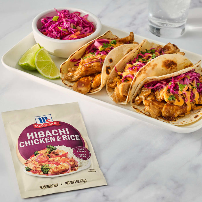 McCormick's Hibachi Chicken Spice is featured alongside a plate of delicious-looking chicken tacos with a side of slaw and lime wedges.
