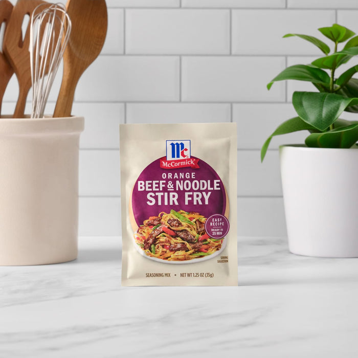 A packet of McCormick Beef &amp; Noodle Stir Fry seasoning mix is displayed on a kitchen counter.