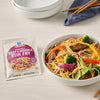 A bowl of beef and noodle stir fry with vegetables is displayed next to a McCormick Beef &amp; Broccoli Stir Fry seasoning packet.
