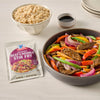 A prepared McCormick Sesame Ginger Stir Fry dish is displayed with rice and soy sauce.