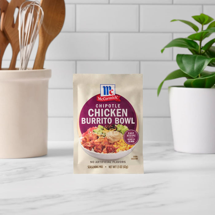 A packet of McCormick Slow Cookers Chicken Burrito Bowl mix stands on a white countertop.