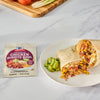 A McCormick Organic Chicken Burrito Bowl seasoning packet is displayed next to a cut burrito and guacamole.