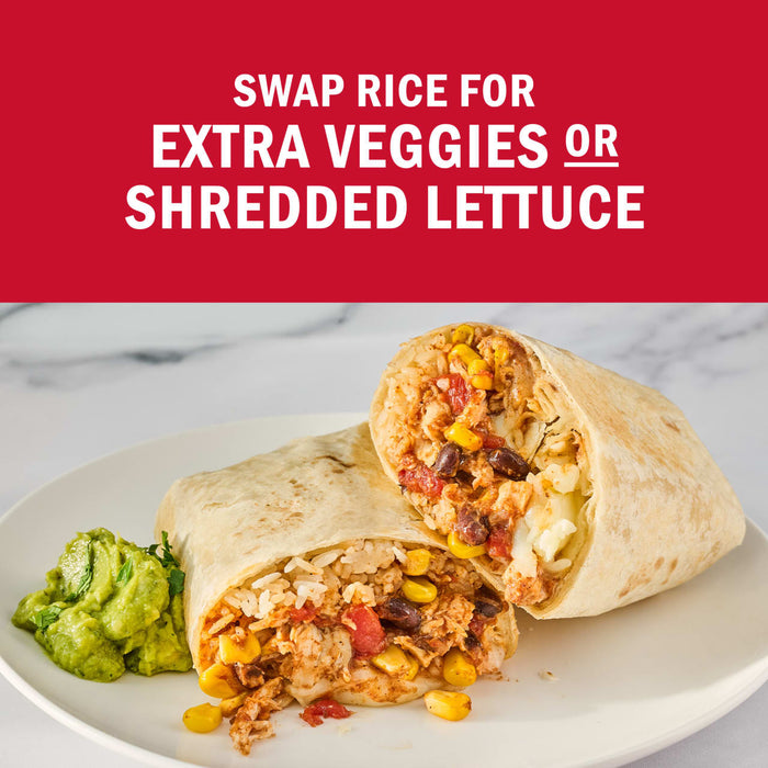 A burrito cut in half on a plate with guacamole, promoting the option to swap rice for extra veggies or shredded lettuce.