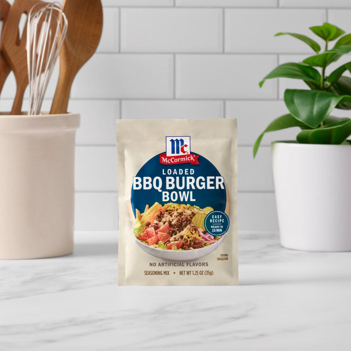 A packet of McCormick Loaded BBQ Burger Bowl seasoning mix sits on a kitchen counter.