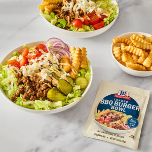Two bowls of JFC Hamburger Bowl salad with fries, featuring ground beef, lettuce, tomatoes, pickles, red onion, and shredded cheese.