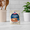 A packet of McCormick One Pot Lasagna Soup mix stands on a countertop.