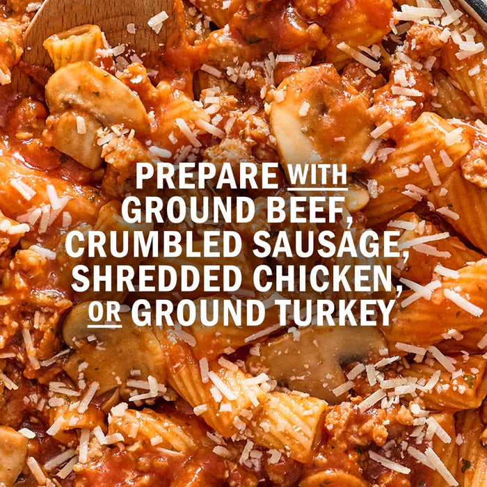 A close-up of pasta with meat sauce, mushrooms, and parmesan cheese, suggesting it can be prepared with ground beef, crumbled sausage, shredded chicken, or ground turkey.