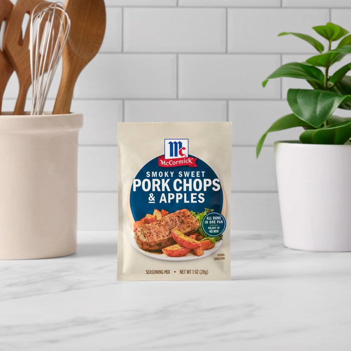 A packet of McCormick Sweet and Savory Pork Chops and Apples seasoning mix sits on a kitchen counter.