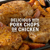 Pork chops and chicken are shown with a side of roasted sweet potatoes and apples.