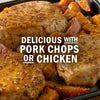 Pork chops and chicken are shown with a side of roasted sweet potatoes and apples.
