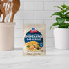A packet of McCormick Ham and Cheese Chicken &amp; Rice Casserole mix stands on a countertop.