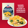 A box of McCormick Mom's Cheesy Chicken &amp; Rice Casserole mix is displayed next to a prepared casserole dish, highlighting the savory, cheesy flavor for a homemade meal.