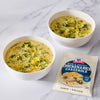 Two bowls of broccoli cheddar soup are displayed next to a packet of McCormick Broccoli Cheddar Cheese Soup Mix.