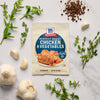McCormick Perfect Roast Chicken &amp; Vegetables seasoning packet is displayed with fresh thyme, garlic, and peppercorns.