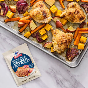 A sheet pan meal featuring McCormick Perfect Pinch Chicken and Vegetables seasoning mix, chicken, carrots, butternut squash, red onion, and apples.