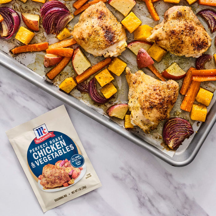 A sheet pan meal featuring McCormick Perfect Pinch Chicken and Vegetables seasoning mix, chicken, carrots, butternut squash, red onion, and apples.