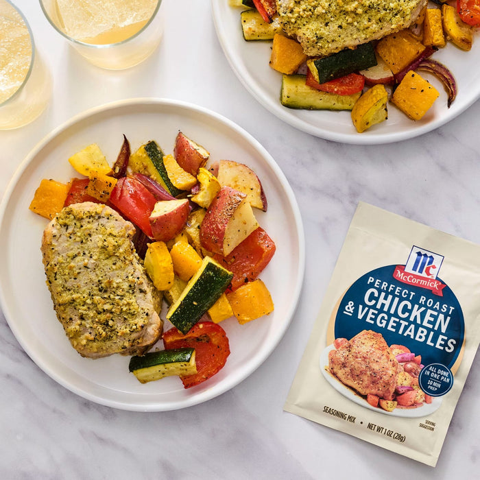 A plate of McCormick Perfectly Dressed Chicken &amp; Vegetables seasoning mix meal with roasted vegetables and chicken.