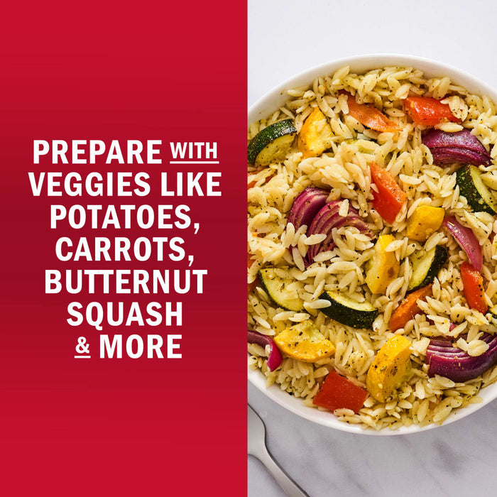 A bowl of pasta salad with colorful vegetables like potatoes, carrots, butternut squash, and more.