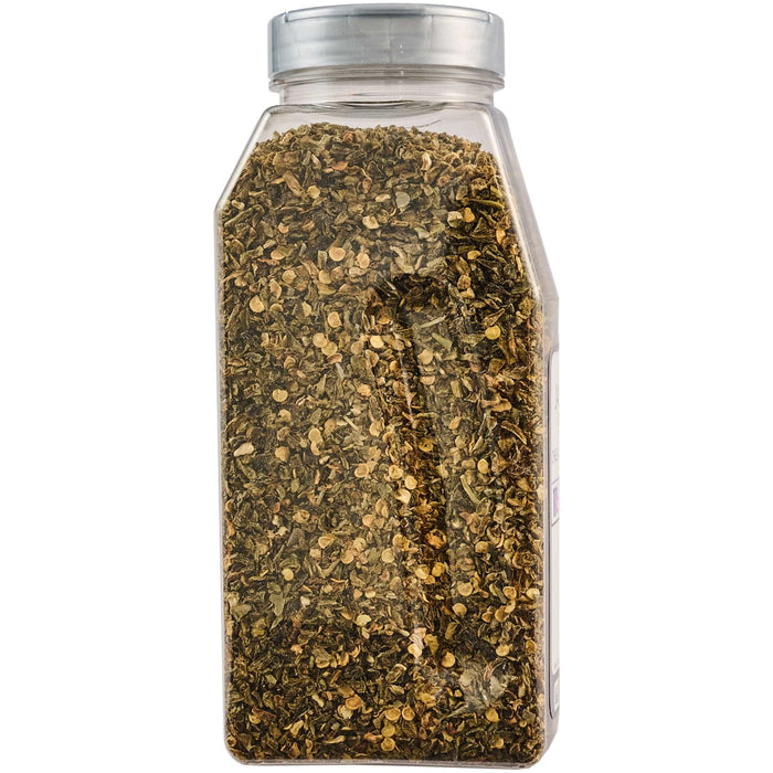 A clear plastic shaker bottle filled with a dark, speckled seasoning blend.