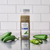 A container of McCormick Jalapeno Pepper sits among fresh jalapenos, showcasing the product's natural source.