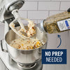 A stand mixer is shown with a paddle attachment mixing ingredients, while a bottle of McCormick Perfect Pinch Salad Supreme Seasoning is being poured into the bowl, highlighting the convenience of no prep needed.
