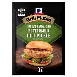 A 1.0 oz packet of Mccormick Grill Mates Buttermilk Dill Pickle Seasoning Mix featuring a grilled chicken sandwich with pickles and tomatoes on a wooden surface.