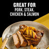 A grilled pork chop topped with charred peaches on a plate demonstrates how Mccormick Grill Mates Tennessee Style Whiskey Honey Marinade Seasoning Mix 1.0 Oz is great for pork steak chicken and salmon.