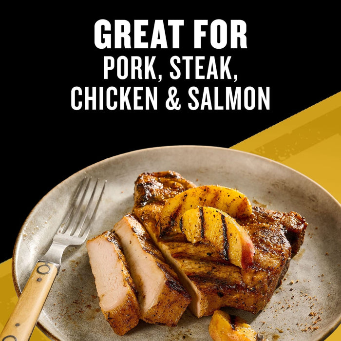 A grilled pork chop topped with charred peaches on a plate demonstrates how Mccormick Grill Mates Tennessee Style Whiskey Honey Marinade Seasoning Mix 1.0 Oz is great for pork steak chicken and salmon.
