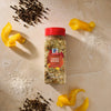 A bottle of Mccormick Turkey Dry Brine Rub, 12.2 Oz is centered on a stone surface surrounded by its key ingredients including piles of coarse sea salt, black peppercorns, and fresh orange peels.