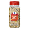 A clear plastic bottle with a red flip-top lid contains Mccormick Turkey Dry Brine Rub, 12.2 Oz, featuring a blend of coarse salt and herbs visible through the container.