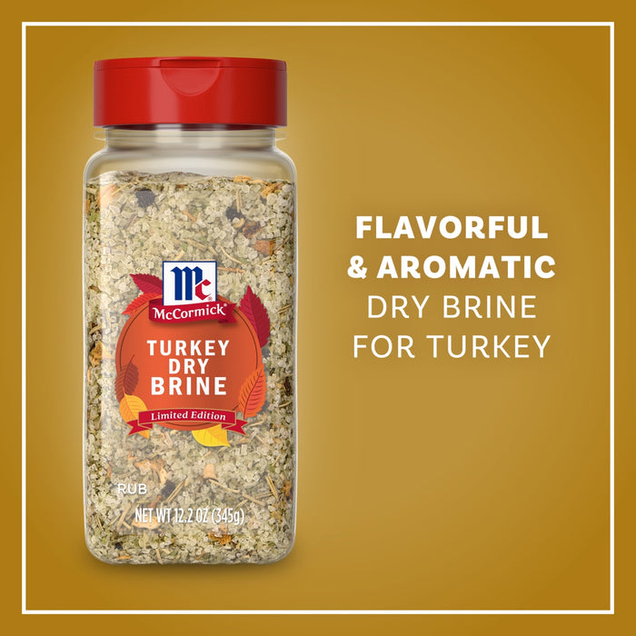 A clear bottle of Mccormick Turkey Dry Brine Rub, 12.2 Oz is displayed against a golden background, highlighting its flavorful and aromatic qualities for seasoning turkey.