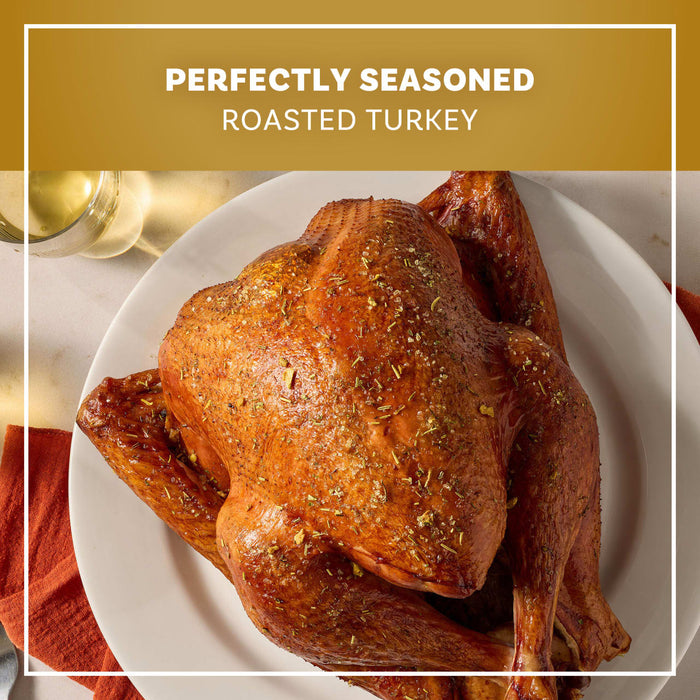 A golden brown roasted turkey sits on a white platter seasoned with Mccormick Turkey Dry Brine Rub, 12.2 Oz for a perfectly seasoned holiday meal.