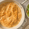A white skillet holds creamy chicken breasts prepared with Mccormick Marry Me Chicken Seasoning Mix, 0.75 Oz, served next to a fresh salad.