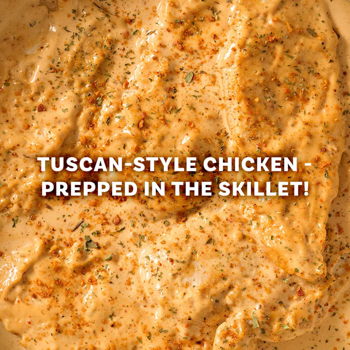 A close-up of Tuscan-style chicken prepared in a skillet, a delicious meal idea using the Mccormick Marry Me Chicken Seasoning Mix, 0.75 Oz.