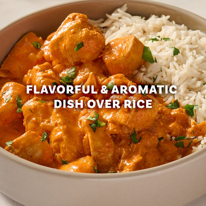 A close-up of a bowl of chicken tikka masala and rice, a flavorful and aromatic dish made using Mccormick Chicken Tikka Masala Seasoning Mix, 0.87 Oz.