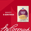 A packet of Mccormick Cacio E Pepe Seasoning Mix, 1.12 Oz is displayed next to a prepared bowl of the pasta dish on a red background.