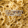 A close-up of a rich and comforting bowl of pasta, made with the Mccormick Cacio E Pepe Seasoning Mix, 1.12 Oz, is topped with grated cheese and black pepper.