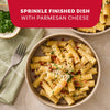 A delicious bowl of rigatoni pasta, prepared using Mccormick Cacio E Pepe Seasoning Mix, 1.12 Oz, is garnished with parmesan cheese and parsley as a serving suggestion.