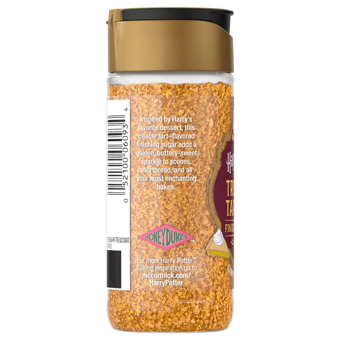A clear shaker bottle of Mccormick Treacle Tart Finishing Sugar Harry Potter 3.43 Oz, a golden, treacle tart-flavored sugar, is shown with its label detailing its use for enchanting bakes.
