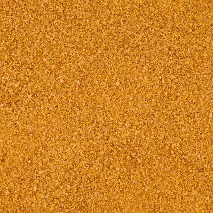 A close-up, top-down view reveals the texture of the Mccormick Harry Potter Licorice Wand Finishing Sugar, 3.39 Oz, showing its light brown, crystalline grains.