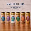 A lineup of six limited edition McCormick Harry Potter Finishing Sugars, including the Mccormick Harry Potter Licorice Wand Finishing Sugar, 3.39 Oz, are displayed on a wooden surface.