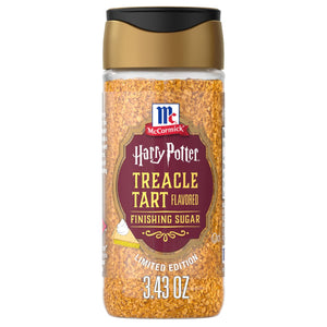 A clear shaker bottle of Mccormick Harry Potter Treacle Tart Finishing Sugar, 3.43 Oz, is shown against a white background, highlighting the golden-brown sugar crystals inside.