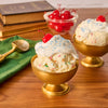 Two golden bowls of ice cream are topped with whipped cream, maraschino cherries, and a festive sprinkle of Mccormick Harry Potter Drooble'S Best Blowing Gum Finishing Sugar, 3.36 Oz.
